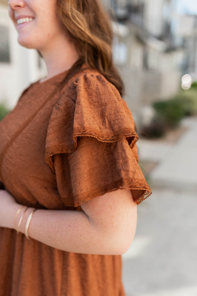 Close up of the sleeve on the plus size chestnut ruffle tiered dress