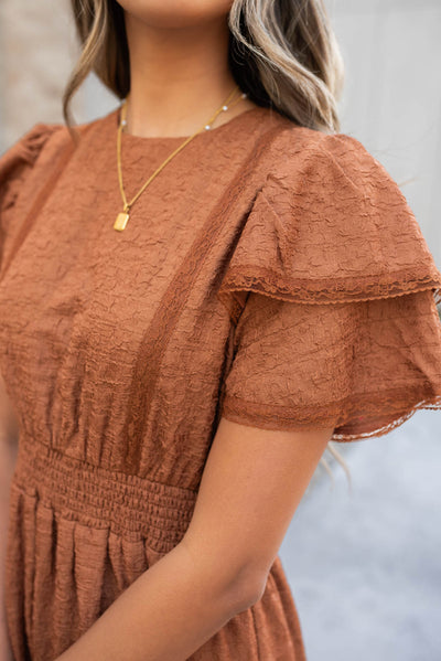 Close up of the sleeve and fabric on the chestnut ruffle tiered dress