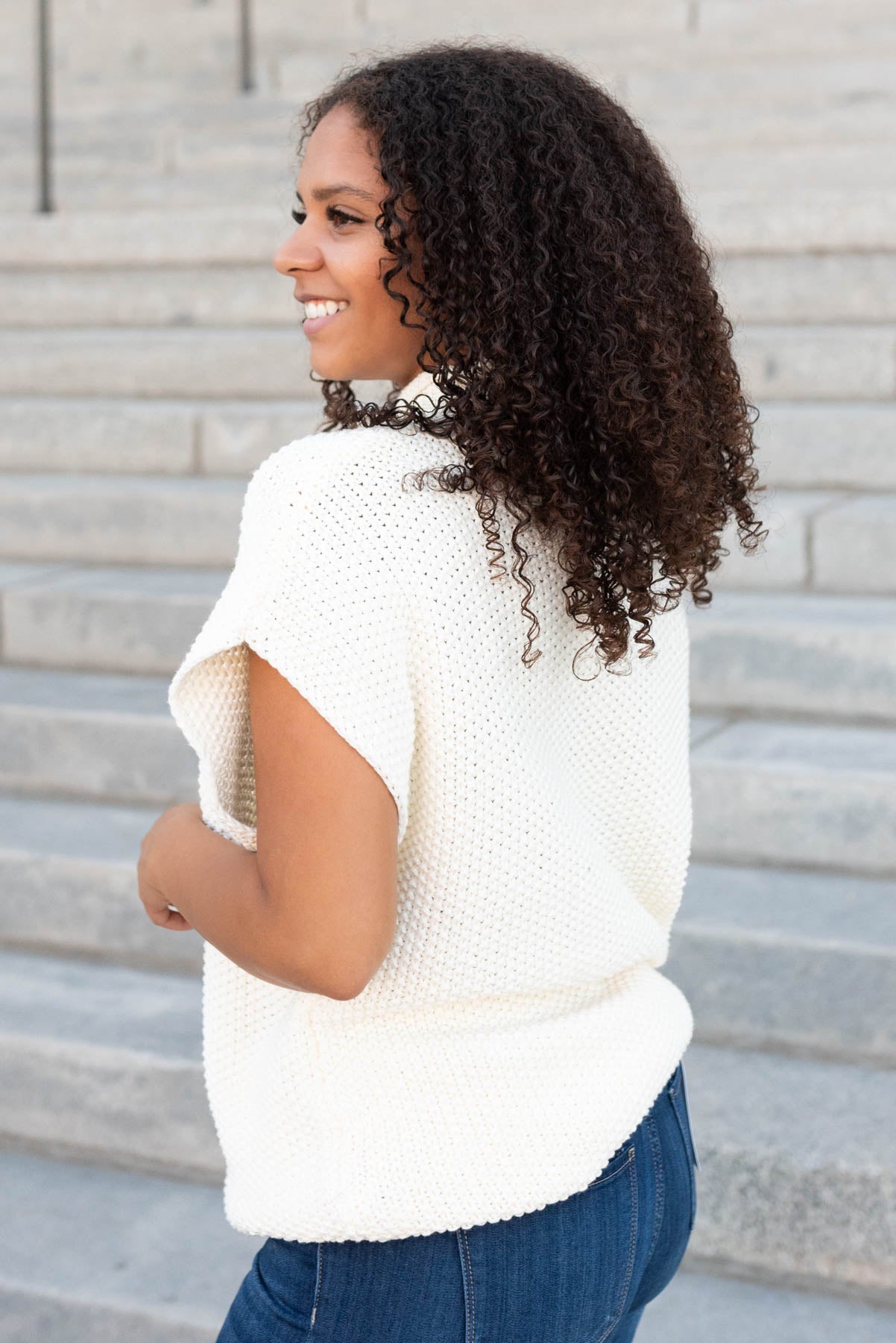 Side view of the cream crochet top