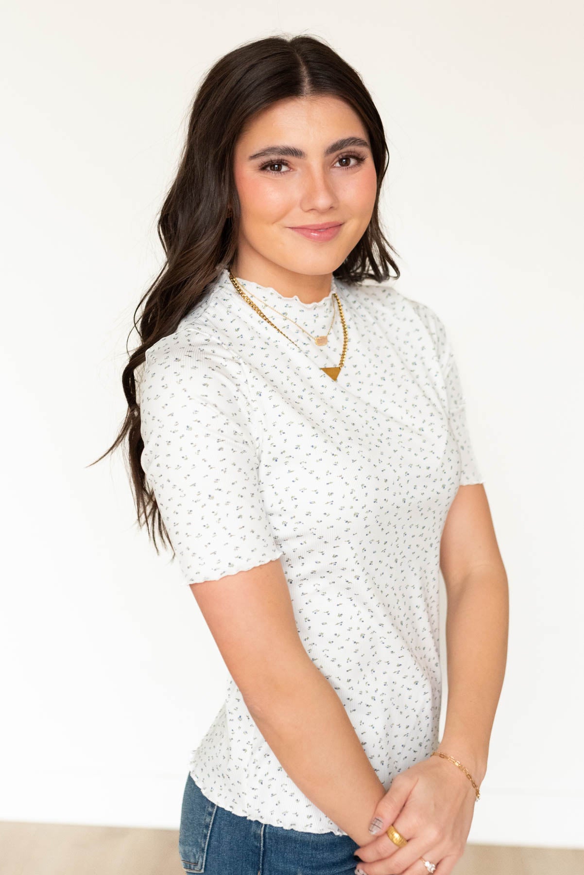 Side view of the ivory floral ruffle top