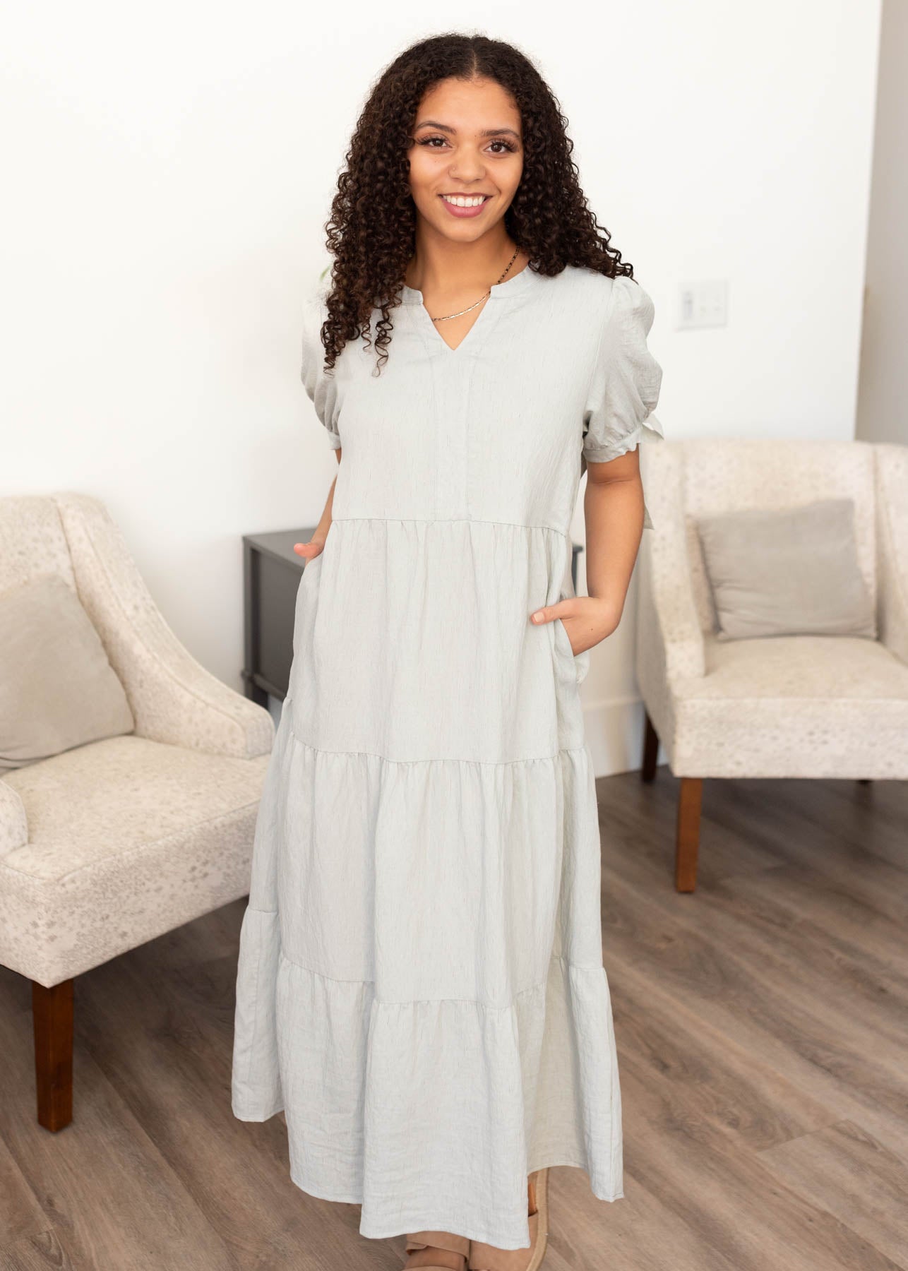 LIght blue tiered dress with short sleeves and pockets