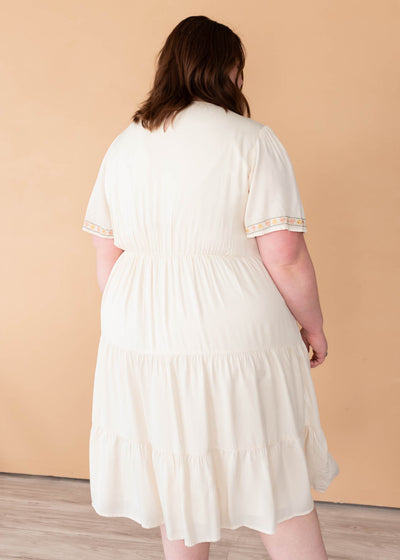 Back view of the ivory embroidered tiered dress in plus size