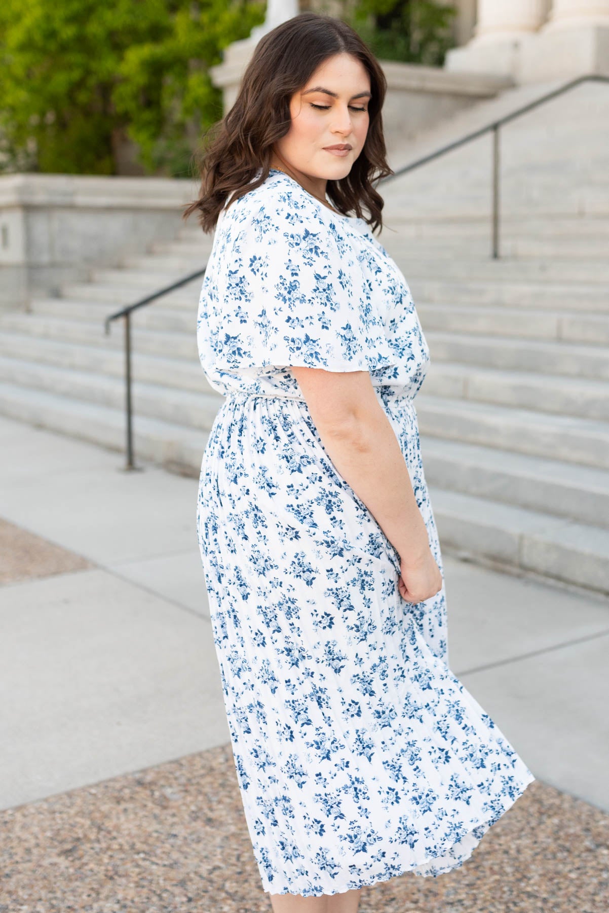 Side view of the blue floral pleated dress