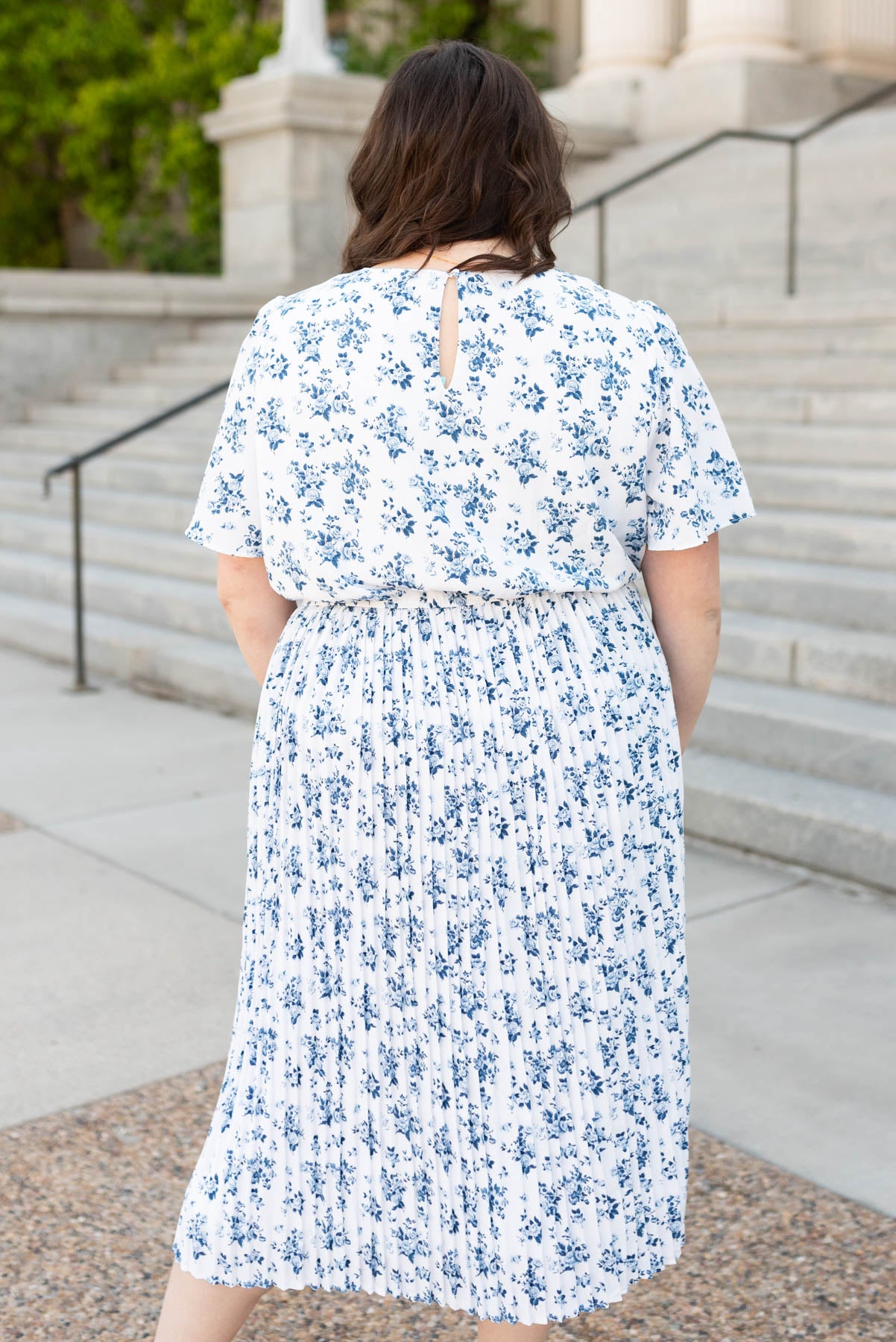 Back view of the blue floral pleated dress