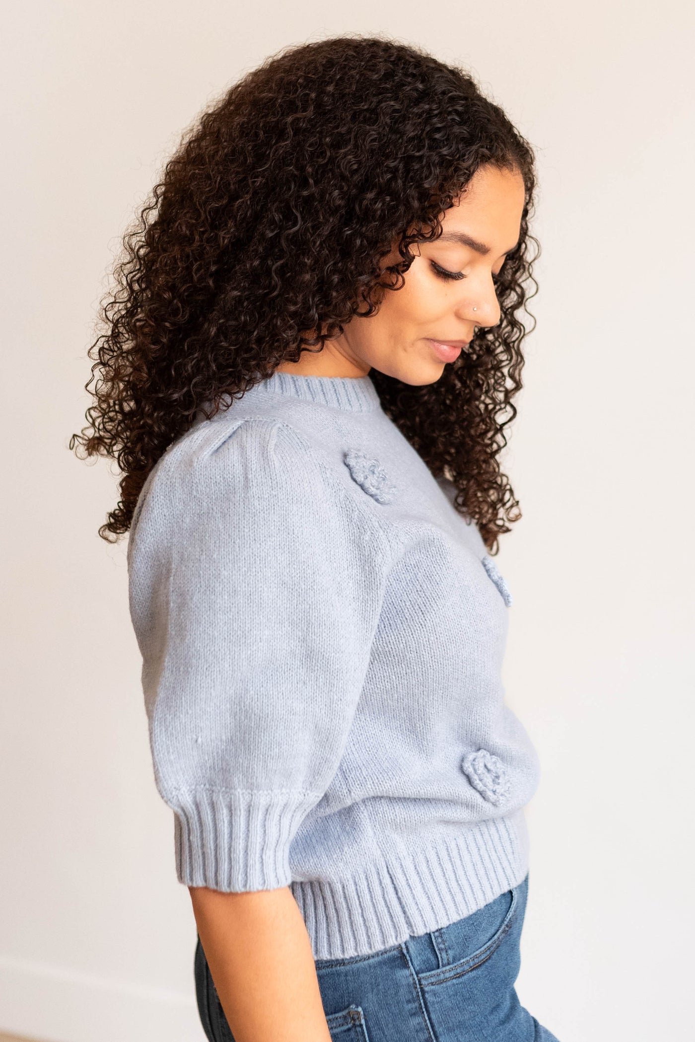 Side view of the dusty blue floral knit sweater