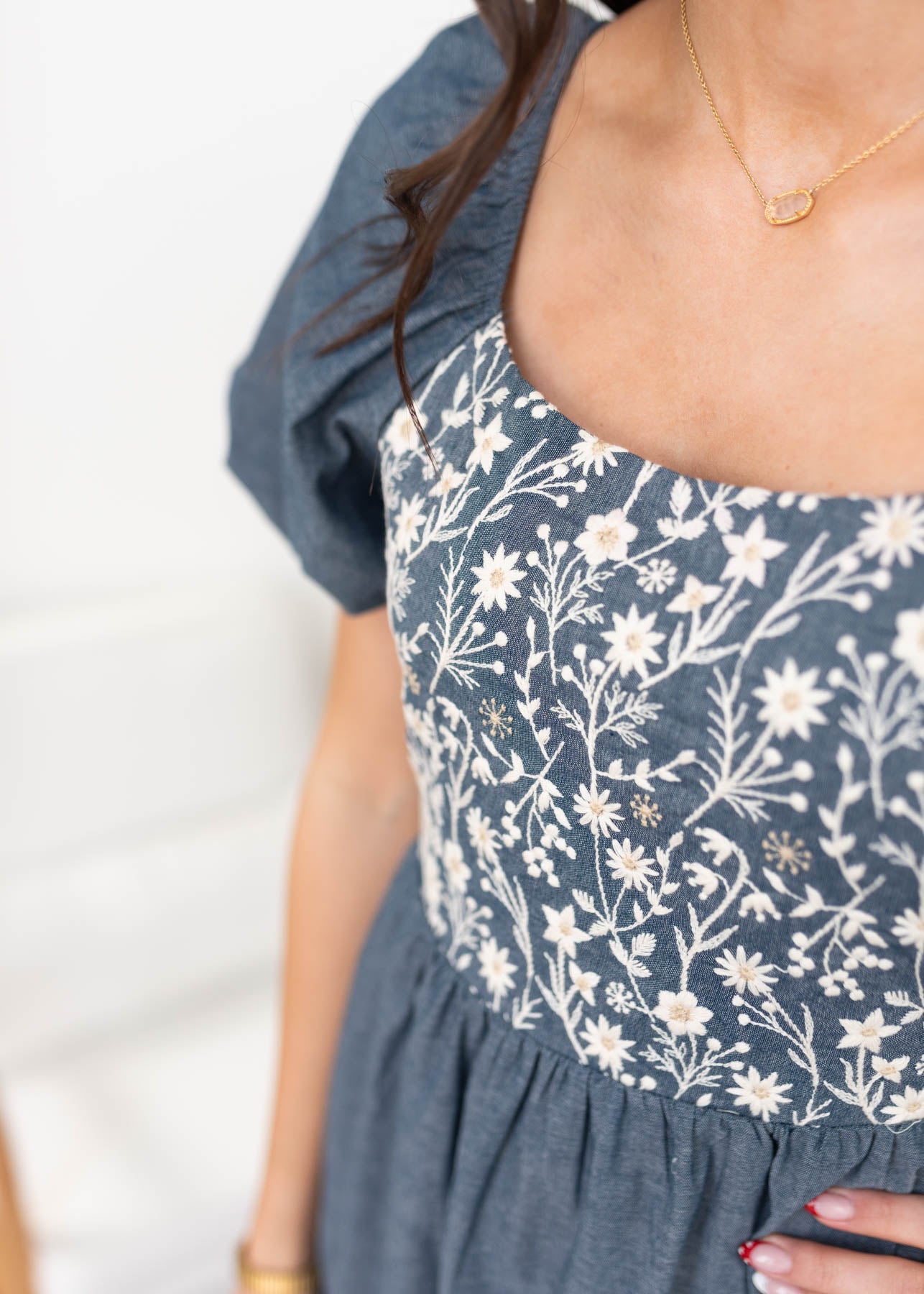 Close up of the floral print denim blue chambray dress