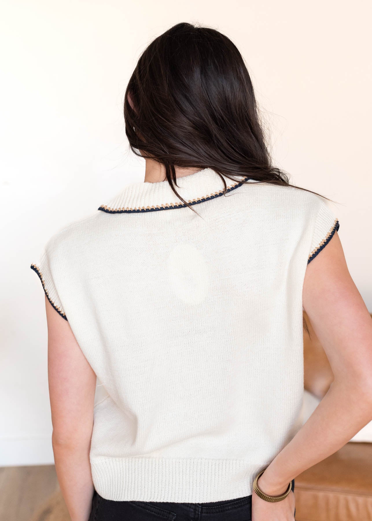 Back view of the ivory button sweater vest