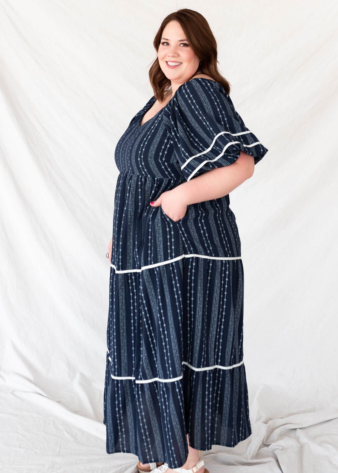 Side view of the plus size navy floral pattern dress