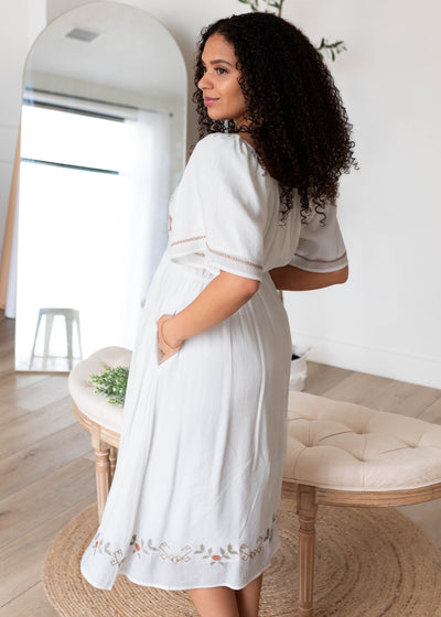 Side view of the white embroidered dress