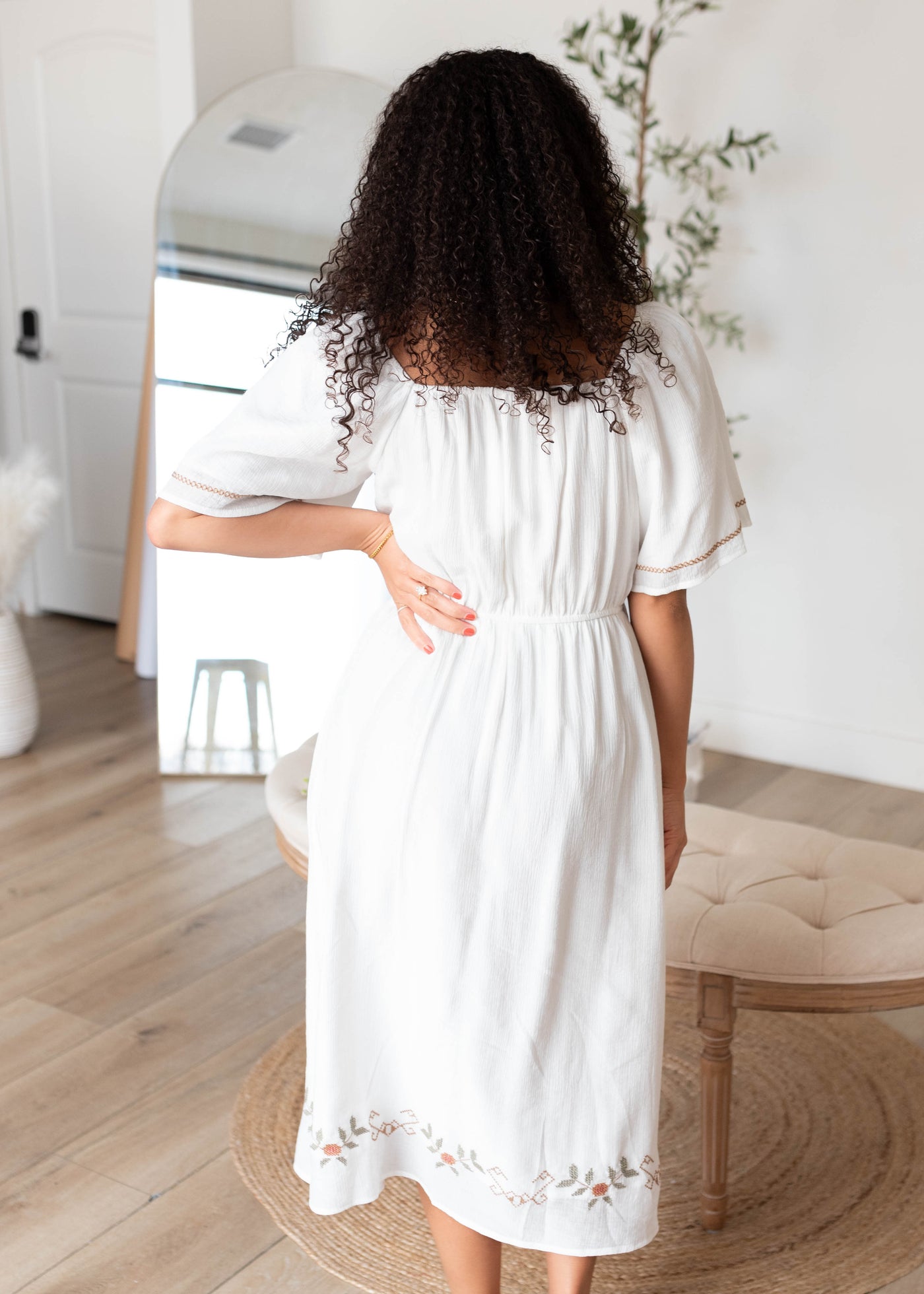 Back view of the white embroidered dress