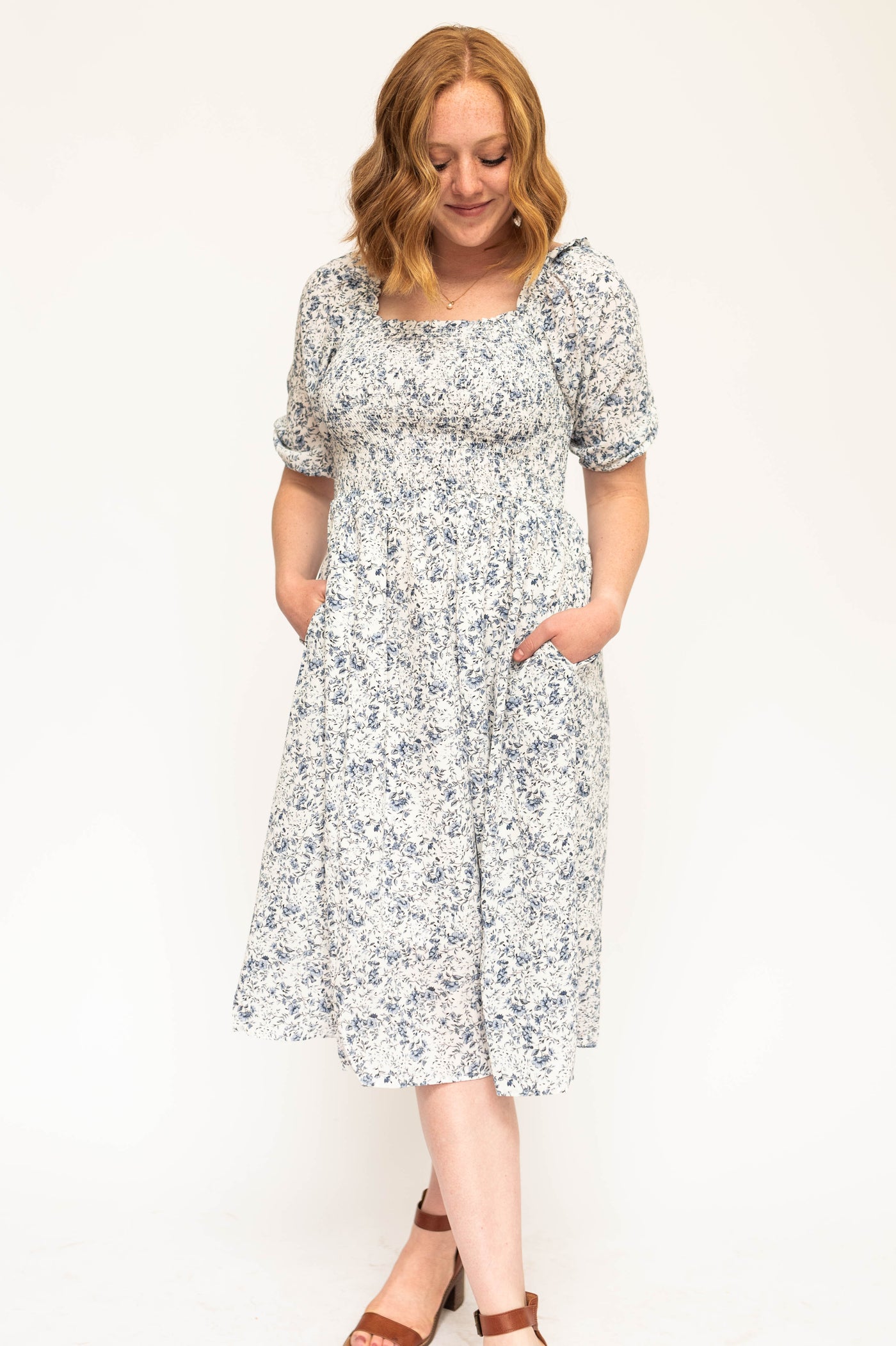 Blue and white short sleeve floral dress with a smocked bodice.