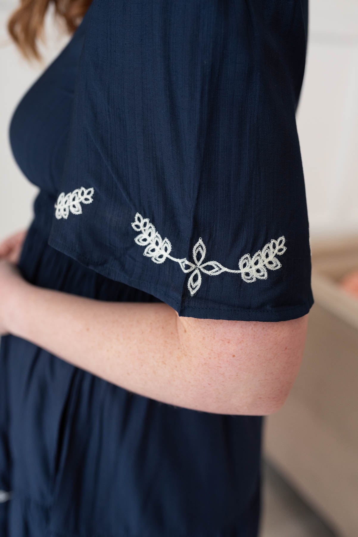 Close up of the embrodiery onthe sleeve of the midnight embroidered dress