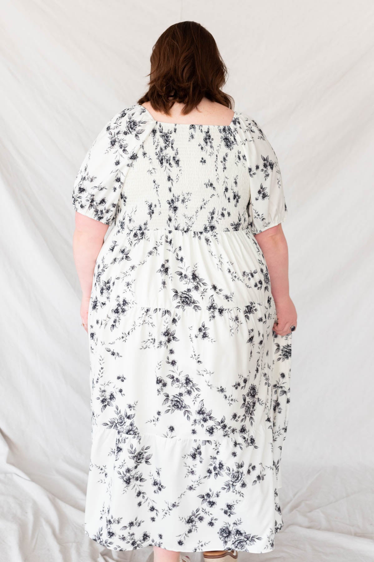 Back view of the plus size ivory floral tiered dress