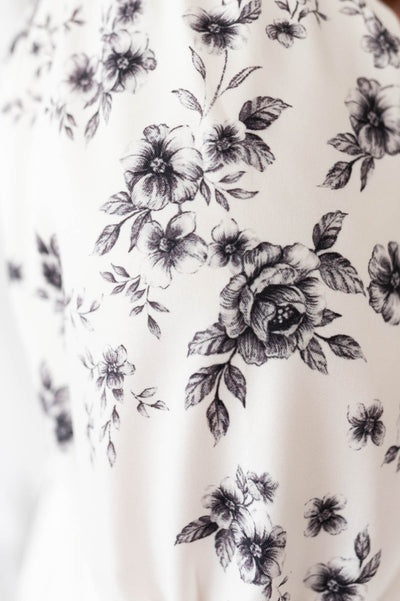 Close up of the fabric on the ivory floral tiered dress