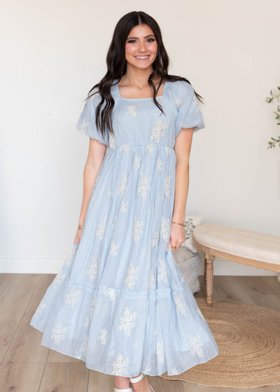 Light blue embroidered dress with a ruffle on the bottom