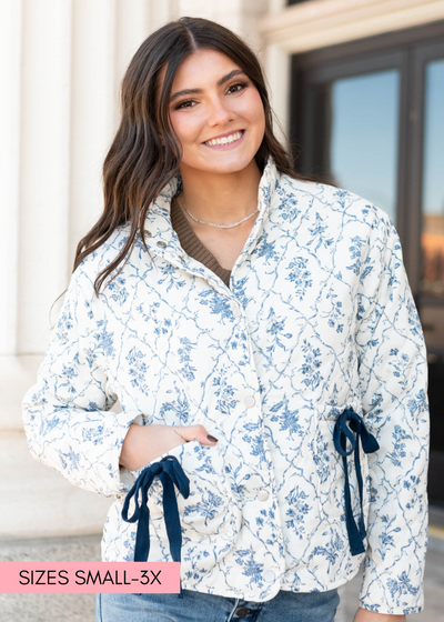 Cream floral printed jacket with front pockets and navy bows