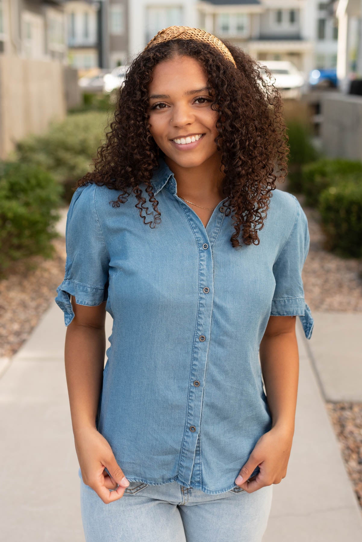 Front view of the button up denim tie sleeve top