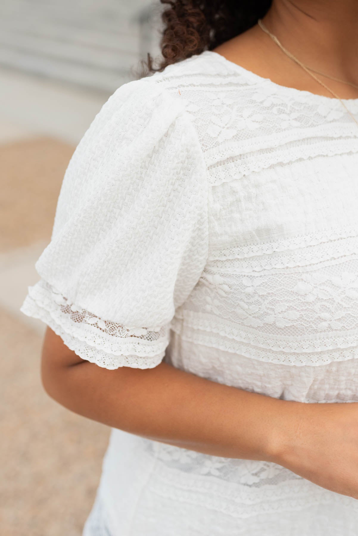 Close up of the sleeve and lace on the white lace top