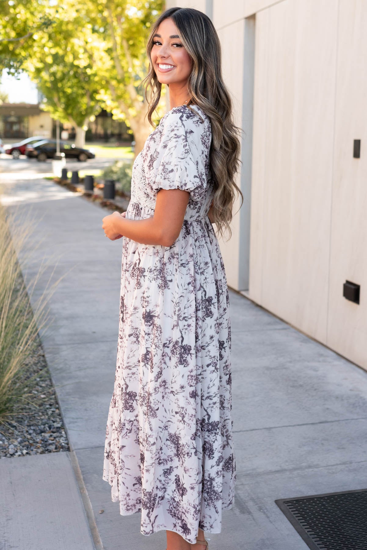 Side view of the cream floral smocked dress