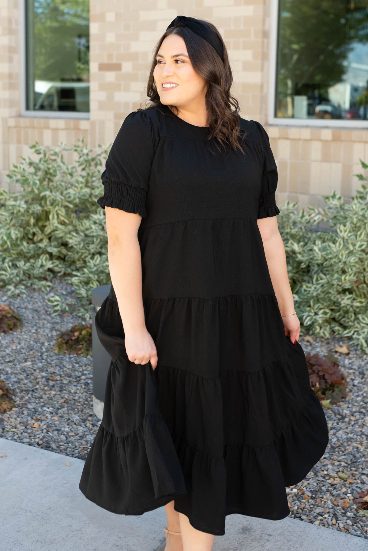 Front view of the plus size tiered black dress 