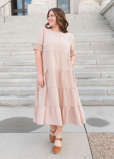 Plus size tiered dusty blush dress with short sleeves