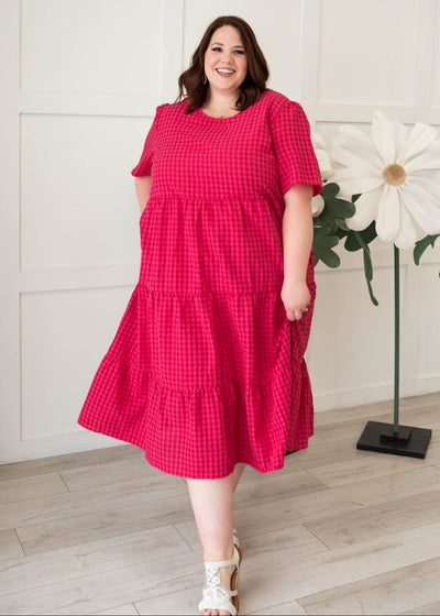 Hot pink gingham tiered dress with short sleeves and pockets in plus size