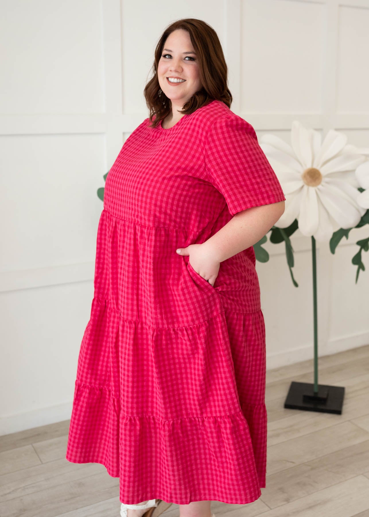 Side view of the hot pink gingham tiered dress in plus size