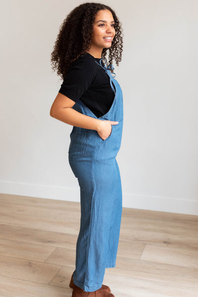 Side view of the indigo washed jumpsuit