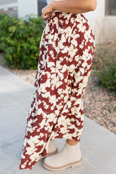 Side view of the burgundy multi floral skirt