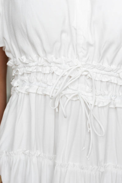 Close up of the waist and ties on the ivory vneck dress