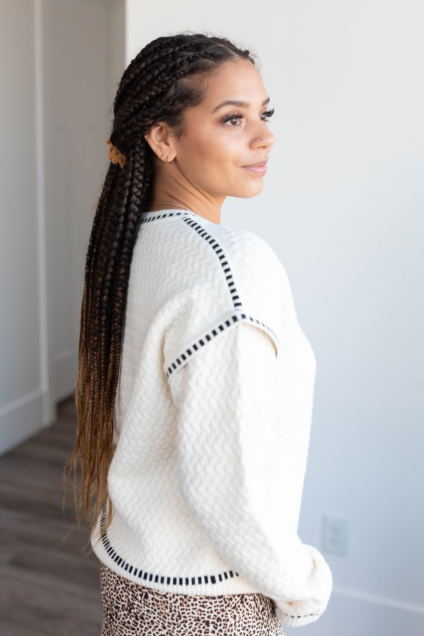 Side view of the cream textured sweater