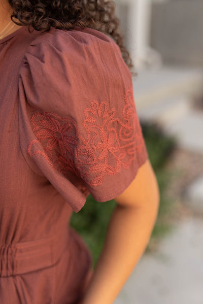 Close up of the sleeve on the burgundy embroidered detail dress 