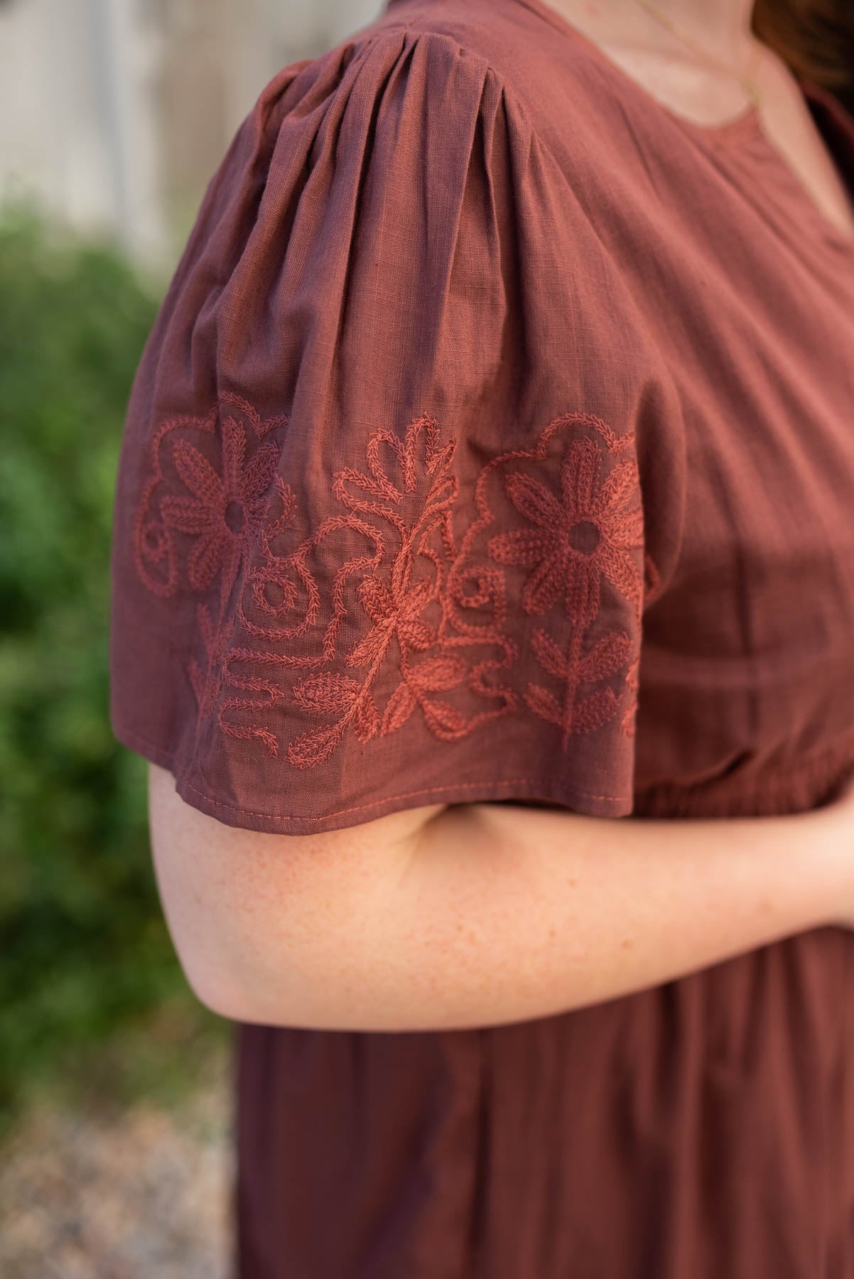 Close up of the embroidery on the burgundy embridered detail dress