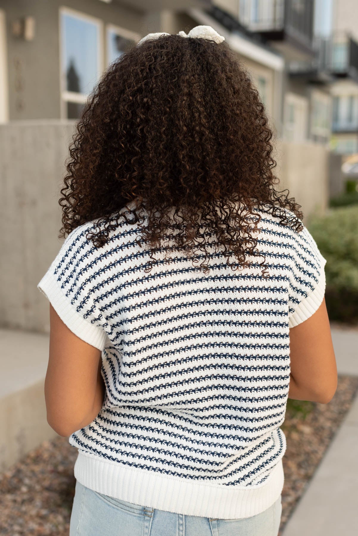 Back view of a blue stirpe sweater top