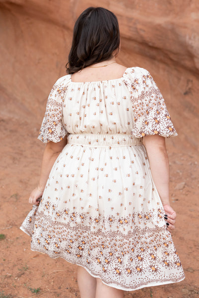 Back view of the plus size beige daisy dress