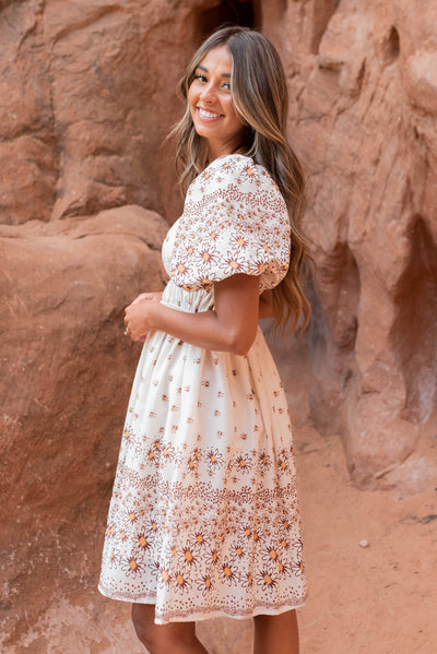 Side view of the beige daisy dress