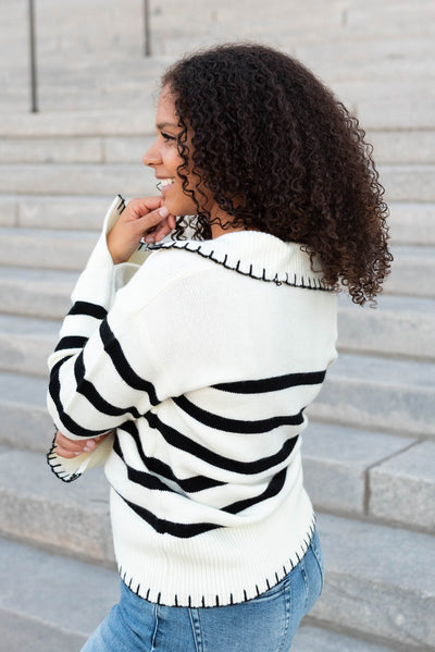 Side view of the ivory black stripe sweater