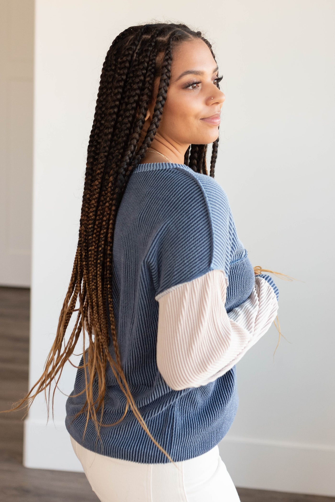 Side view of the dark denim color block top