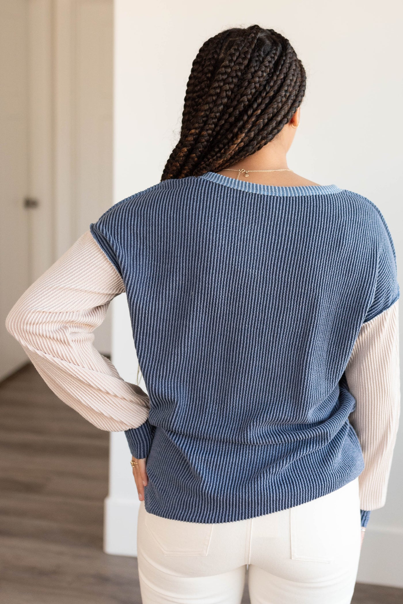 Back view of the dark denim color block top