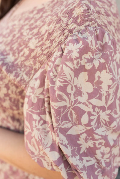 View of the fabric on the plus size dusty plum floral dress