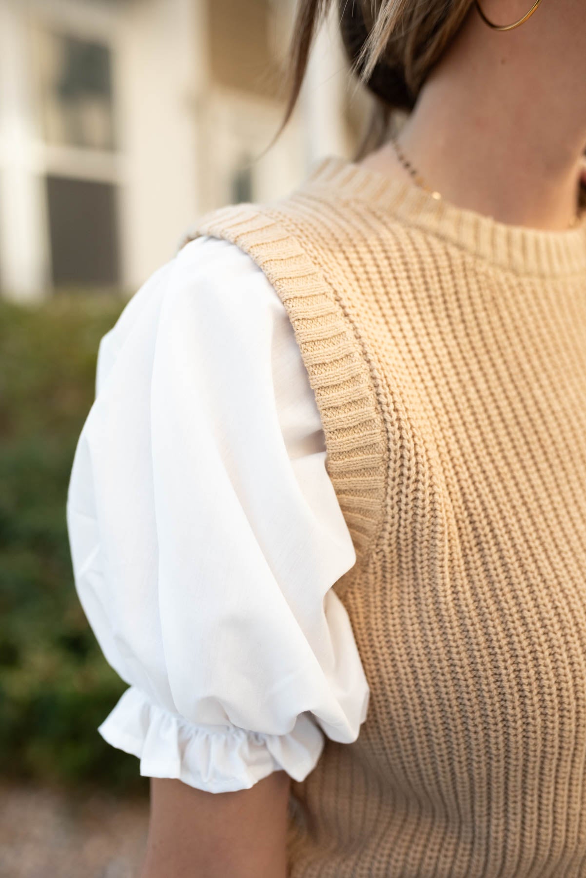 Close up of the sleeve on the taupe sweater top