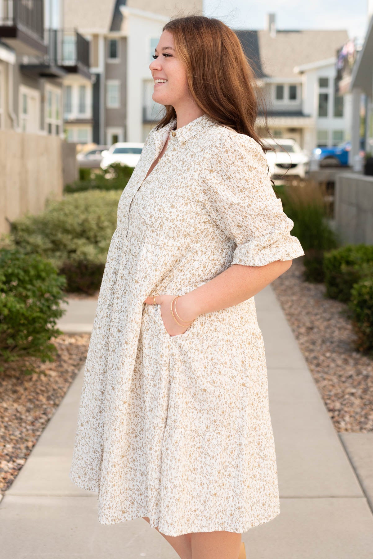 Side view of the plus size taupe floral button dress with pockets