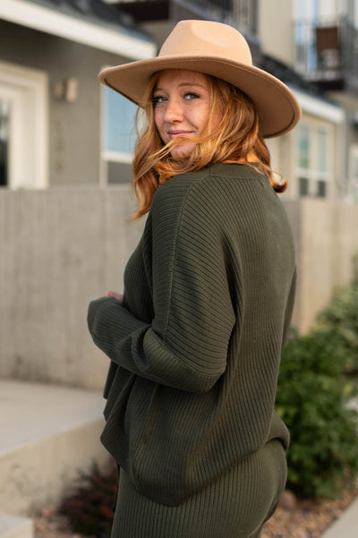 Side view of a dark green sweater