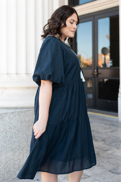 Side view of the plus size navy tie dress