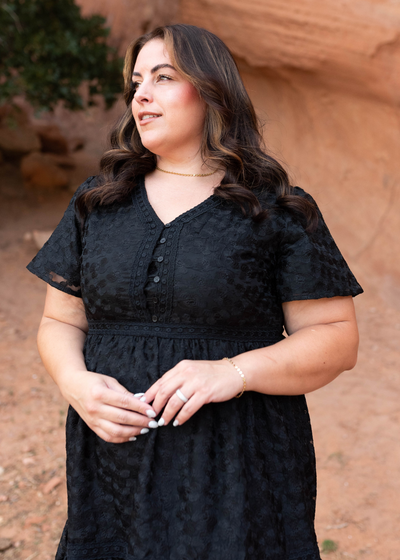 Buttons on the bodice of the plus size black floral lace dress