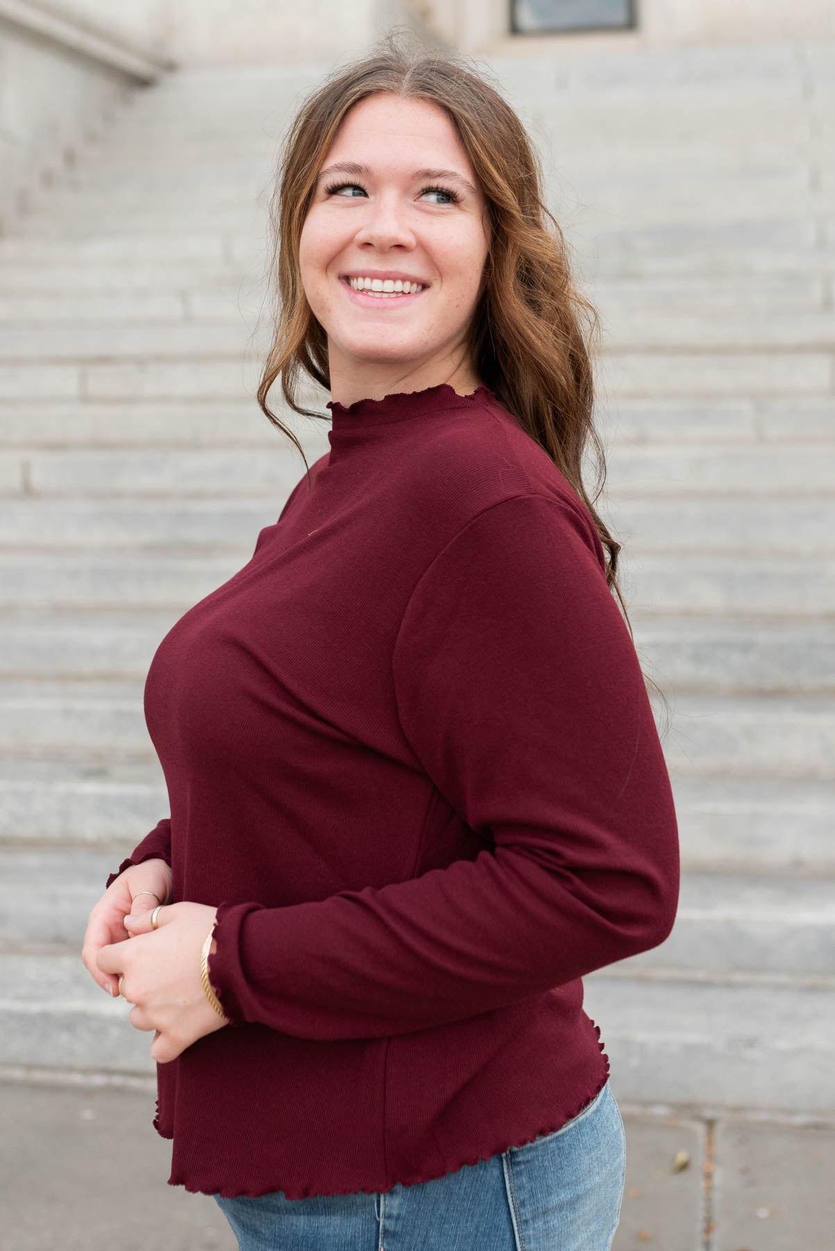 Side view of the plus size burgundy ruffle ribbed top