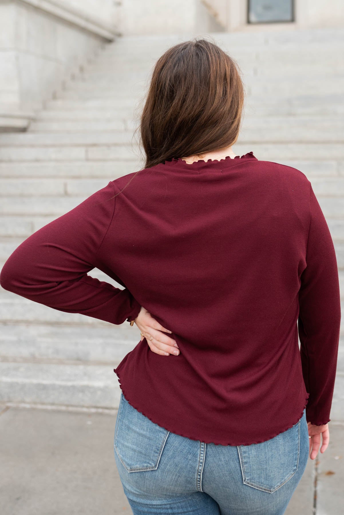 Back view of the plus size  burgundy ruffle ribbed top