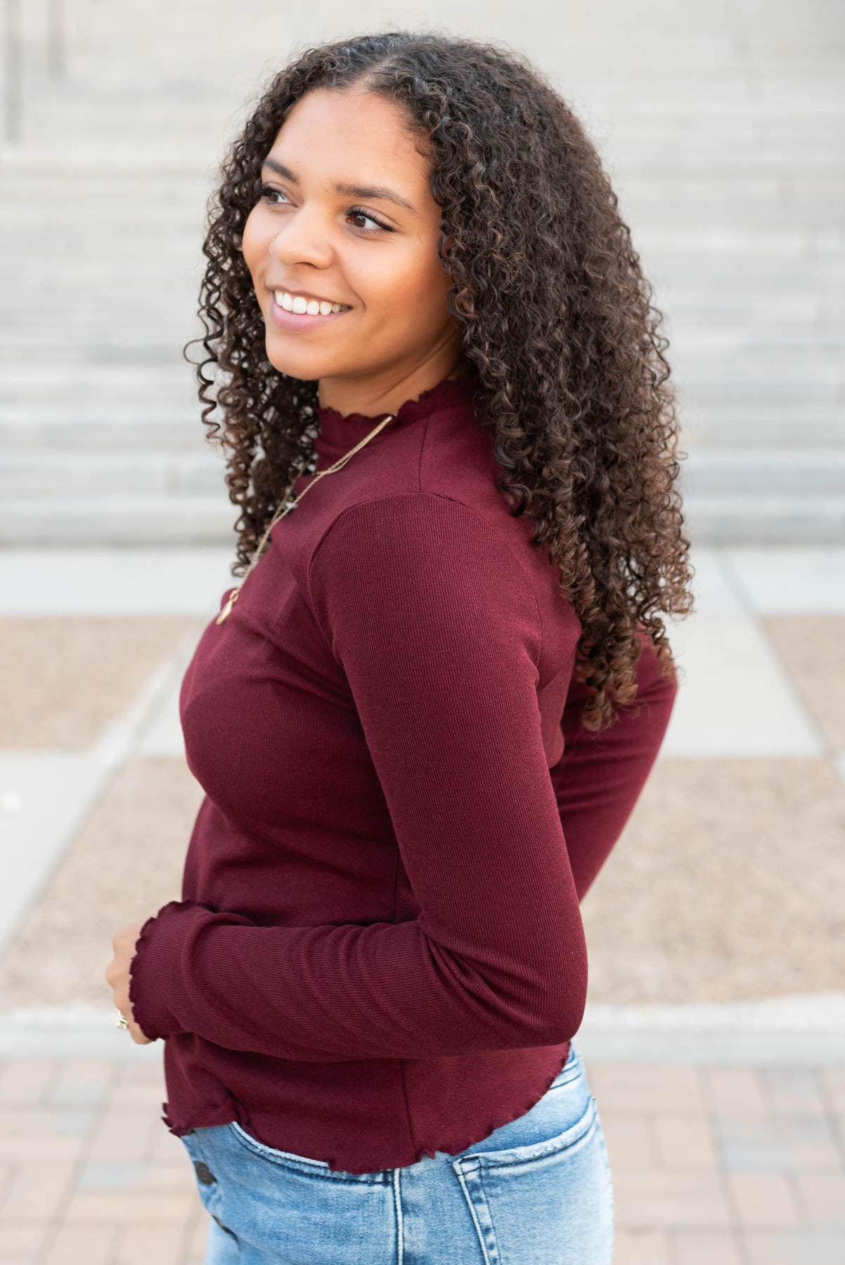 Side view of the burgundy ruffle ribbed top