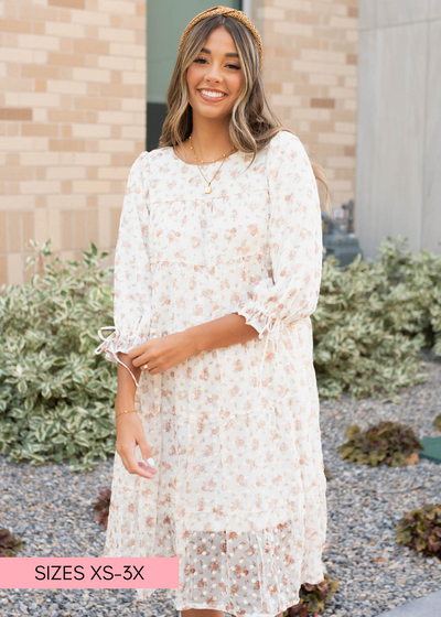 Cream floral dot dress with ties on the cuffs