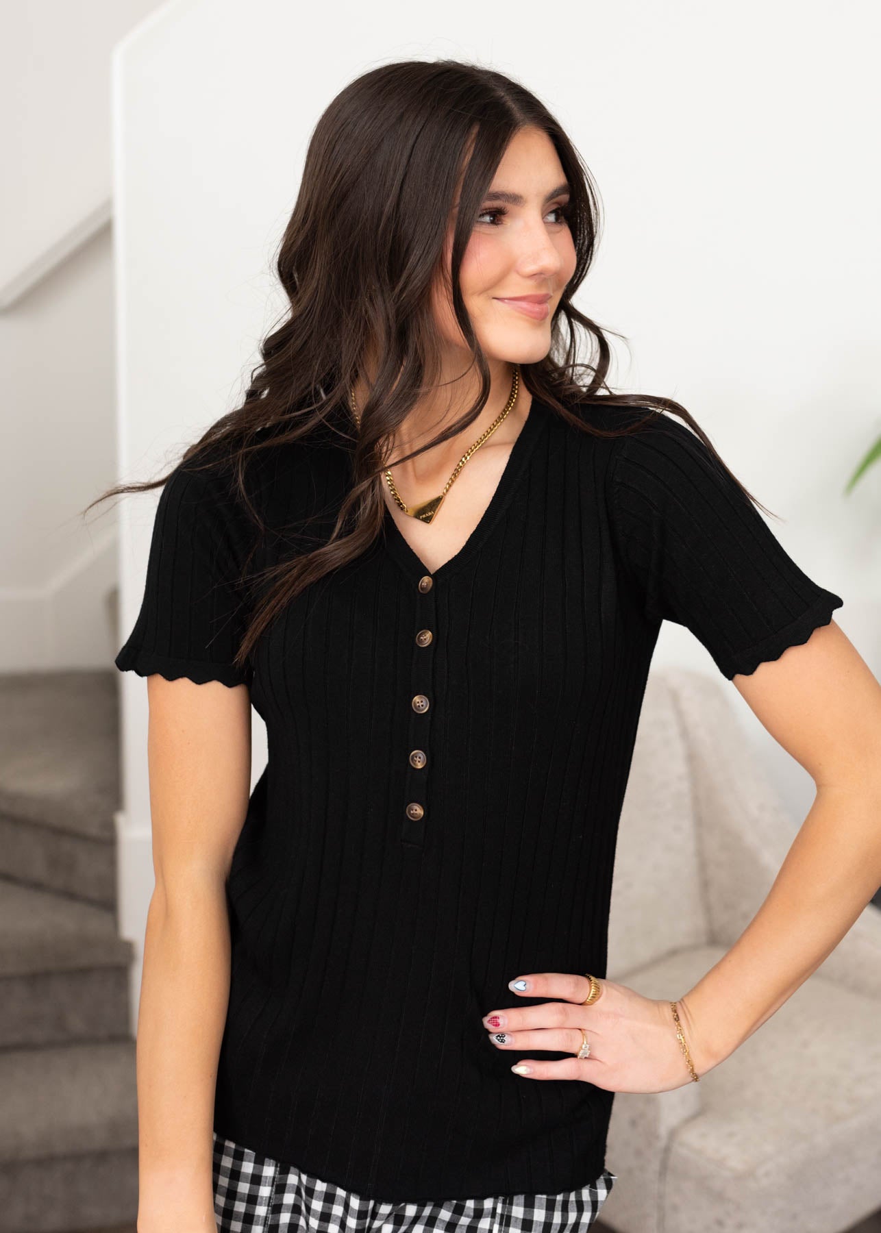 Front view of the black button top with v-neck